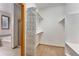 Walk-in closet with wire shelving next to bathroom with tile floors, glass shower and soaking tub at 7288 S Sundown Cir, Littleton, CO 80120