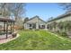 Well-maintained backyard featuring a lush lawn, gazebo, patios, and mature trees at 4965 Dover St, Arvada, CO 80002