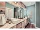 Charming bathroom features stylish vessel sinks, rustic wood accents, and modern fixtures at 4965 Dover St, Arvada, CO 80002