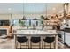 Bright kitchen with quartz island, stylish pendant lights, and floating shelves, perfect for cooking at 4965 Dover St, Arvada, CO 80002