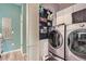 Practical laundry room equipped with modern washer and dryer units and organized storage solutions at 4965 Dover St, Arvada, CO 80002