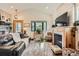 Cozy living room with fireplace, wood floors, and large windows, perfect for relaxation at 4965 Dover St, Arvada, CO 80002