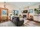 Bright living room with wood floors, fireplace, large windows, vaulted ceilings, and stylish decor at 4965 Dover St, Arvada, CO 80002