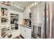 Charming pantry featuring white shelves and cabinets, ideal for organized storage and efficient space utilization at 4965 Dover St, Arvada, CO 80002