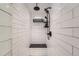Elegant shower with sleek subway tile, black fixtures, and a built-in bench for a spa-like experience at 4965 Dover St, Arvada, CO 80002