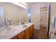 Bright bathroom featuring double sinks, tile flooring, and a separate shower and bath at 16873 Boreas Ct, Parker, CO 80134