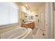 Bright bathroom featuring a large soaking tub and double vanity at 16873 Boreas Ct, Parker, CO 80134