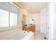 Bright bathroom with double sinks, soaking tub, and large window at 16873 Boreas Ct, Parker, CO 80134