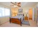 Cozy bedroom with natural light, a ceiling fan, and a decorative wooden bed frame and side tables at 16873 Boreas Ct, Parker, CO 80134