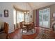 Cozy dining area with vaulted ceilings, a round table, and natural light from large windows at 16873 Boreas Ct, Parker, CO 80134