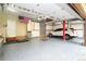 Spacious garage with epoxy flooring and ample storage space, as well as an American flag on the wall at 16873 Boreas Ct, Parker, CO 80134
