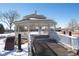 Elegant gazebo with railings and a ramp, set in a snowy landscape at 16873 Boreas Ct, Parker, CO 80134