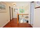 Bright hallway with decorative lighting, hardwood floors, and stained glass window accents on the upper level at 16873 Boreas Ct, Parker, CO 80134