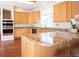 Well-appointed kitchen with stainless steel appliances, light cabinetry and a large breakfast bar at 16873 Boreas Ct, Parker, CO 80134