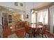 Cozy eat-in kitchen with wood floors, a breakfast bar, light wood cabinets, and natural light at 16873 Boreas Ct, Parker, CO 80134