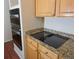 Close-up of kitchen with granite countertops, built-in oven, and an induction cooktop at 16873 Boreas Ct, Parker, CO 80134