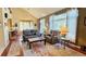 Spacious living room with vaulted ceilings, large windows, and comfortable leather furnishings at 16873 Boreas Ct, Parker, CO 80134