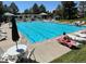 Community pool with lounge chairs, tables, umbrellas and well-maintained landscaping at 16873 Boreas Ct, Parker, CO 80134