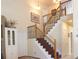 Open staircase featuring wood and iron railing and natural light at 16873 Boreas Ct, Parker, CO 80134