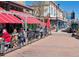 Bustling street view of a lively outdoor patio featuring red awnings on a sunny day, and street view of retail shops at 16873 Boreas Ct, Parker, CO 80134