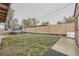 Spacious backyard with a trampoline, green grass, and a privacy fence, perfect for outdoor activities at 9391 Lilly Ct, Thornton, CO 80229