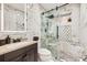 Elegant bathroom featuring marble-style tile and glass-enclosed shower at 9391 Lilly Ct, Thornton, CO 80229