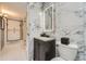 Stylish bathroom with sleek vanity and lighted mirror above the commode at 9391 Lilly Ct, Thornton, CO 80229