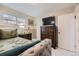 Bedroom featuring a daybed with a television and decorative accents at 9391 Lilly Ct, Thornton, CO 80229