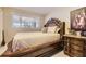 Bedroom with a decorative wood dresser and accents with a bright window at 9391 Lilly Ct, Thornton, CO 80229