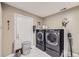 Well-equipped laundry room with modern washer and dryer, ample storage, and a clean, organized layout at 9391 Lilly Ct, Thornton, CO 80229