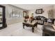 Elegant living room with large window, tile floors, and decorative furnishings at 9391 Lilly Ct, Thornton, CO 80229
