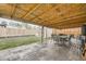 Enjoy outdoor dining on this covered patio with a dining table and a spacious backyard at 9391 Lilly Ct, Thornton, CO 80229