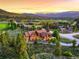 Panoramic aerial view of a beautiful mountain home surrounded by lush greenery and breathtaking mountain views at 59 Gold Run Rd, Breckenridge, CO 80424