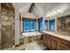 Bright bathroom featuring a soaking tub with a view of the outdoors, plus a tiled shower and vanity at 59 Gold Run Rd, Breckenridge, CO 80424