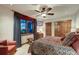 Bedroom with carpeted floors, neutral paint, ceiling fan, window with curtains, and ensuite access at 59 Gold Run Rd, Breckenridge, CO 80424