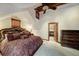 Bedroom featuring luxurious bed, dresser, and an open doorway to another room at 59 Gold Run Rd, Breckenridge, CO 80424