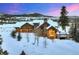 Inviting home featuring a stone facade, attached garage, and snowy landscape with mountain views at 59 Gold Run Rd, Breckenridge, CO 80424
