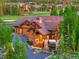 Beautiful home with a lush green lawn, mature trees, and an attached three car garage at 59 Gold Run Rd, Breckenridge, CO 80424