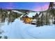 Charming exterior view of mountain home with driveway, snow-covered roof, and scenic surroundings at 59 Gold Run Rd, Breckenridge, CO 80424