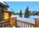 Charming mountain home featuring a wood railing, snow-covered roof, and scenic views at 59 Gold Run Rd, Breckenridge, CO 80424