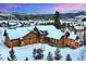 Stunning snow-covered home with a three-car garage and scenic mountain backdrop at 59 Gold Run Rd, Breckenridge, CO 80424