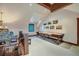 Open game room with a shuffleboard table, exposed beams and a staircase to another floor at 59 Gold Run Rd, Breckenridge, CO 80424