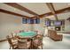 Basement game room featuring poker table with beamed ceilings, recessed lighting, and stone fireplace at 59 Gold Run Rd, Breckenridge, CO 80424