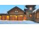 Attached two-car garage with decorative wooden doors and exterior lighting for added curb appeal at 59 Gold Run Rd, Breckenridge, CO 80424