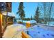 Outdoor hot tub on a snowy deck with stone accents, perfect for relaxation and enjoying the winter scenery at 59 Gold Run Rd, Breckenridge, CO 80424