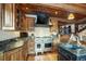 Gourmet kitchen features custom cabinetry, stone countertops, and a professional range at 59 Gold Run Rd, Breckenridge, CO 80424