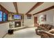 Comfortable living room with stone fireplace, beamed ceilings, neutral carpeting, and comfortable seating at 59 Gold Run Rd, Breckenridge, CO 80424