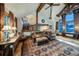 Open living area with wood beams, plush seating, and large windows with mountain views at 59 Gold Run Rd, Breckenridge, CO 80424