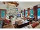 Inviting living room features a stone fireplace, hardwood floors, and comfortable seating at 59 Gold Run Rd, Breckenridge, CO 80424