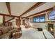 Cozy basement living area with beamed ceilings, stone fireplace, neutral carpeting, and comfortable seating at 59 Gold Run Rd, Breckenridge, CO 80424